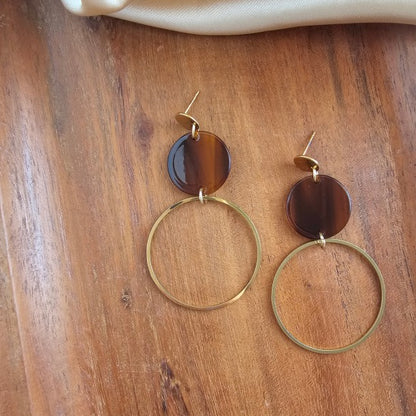 Flat lay of Sadie Earrings in Walnut with glossy walnut acrylic discs and 18k gold plated hoops