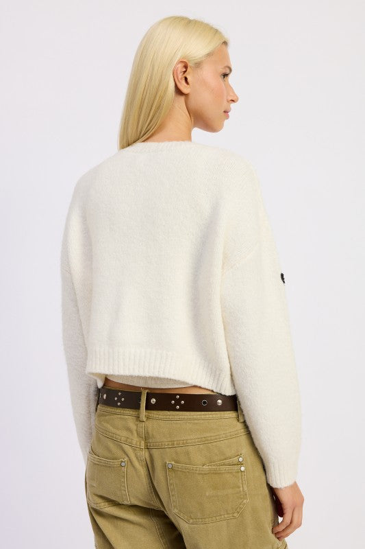 Back view of Donna Cropped Cardigan showing cozy sweater knit texture.