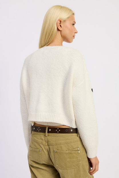 Back view of Donna Cropped Cardigan showing cozy sweater knit texture.