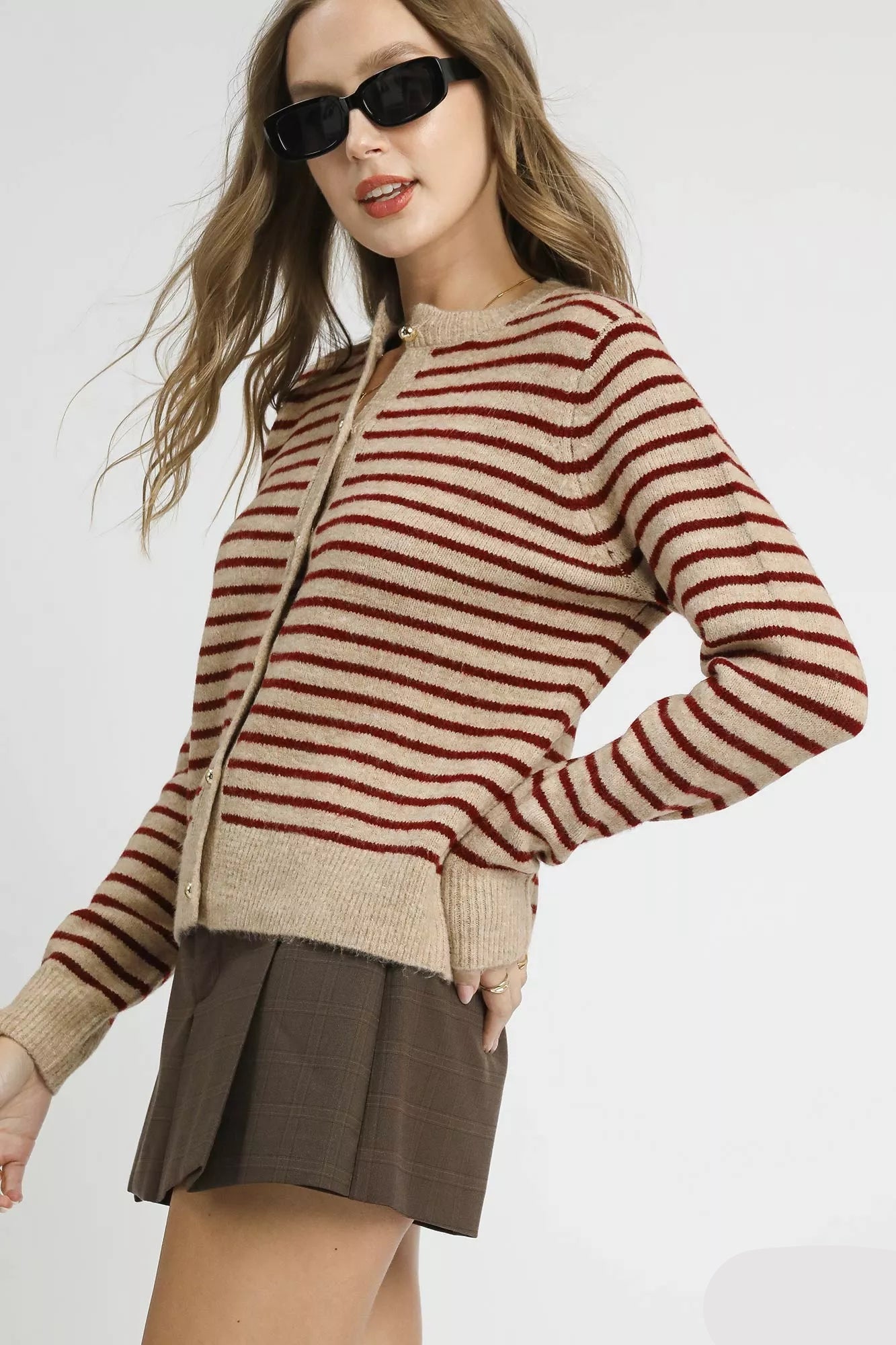 Tan red striped button-up cardigan, side angle showing ribbed hem.