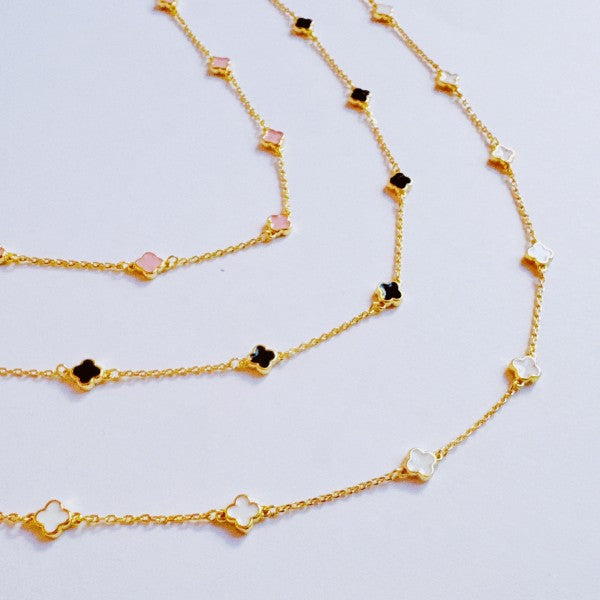 Close-up of Petite Colored Clover Necklace showing enamel clover charm detail.