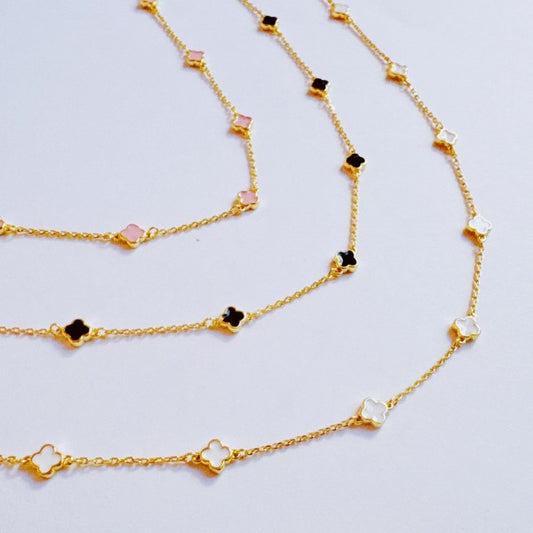 Close-up of Petite Colored Clover Necklace showing enamel clover charm detail.