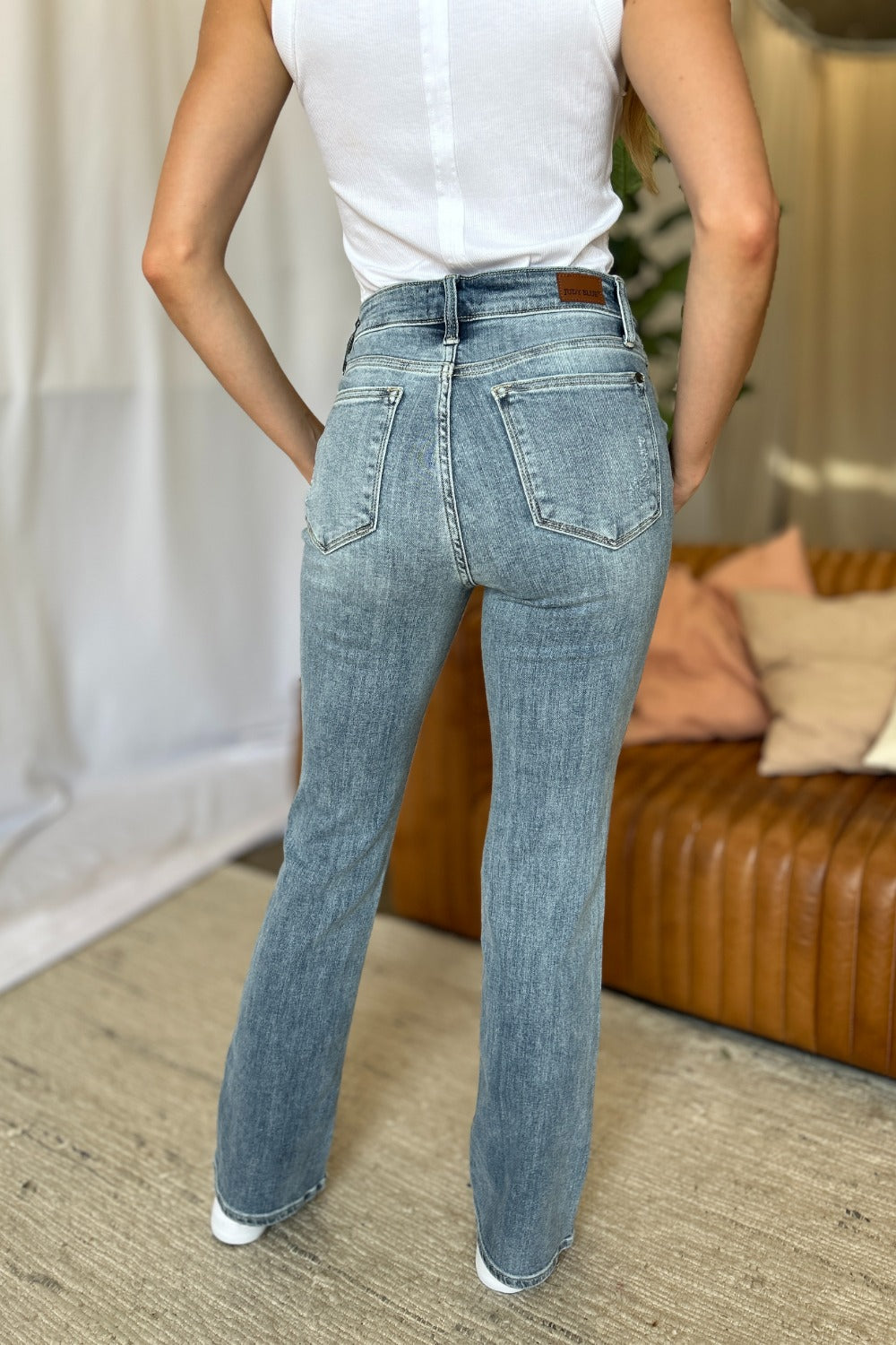 Medium Rise Bootcut Jeans by Judy Blue in light wash. Flattering medium rise, slight flare silhouette, moderate stretch for all-day comfort. Perfect for pairing with boots or heels.