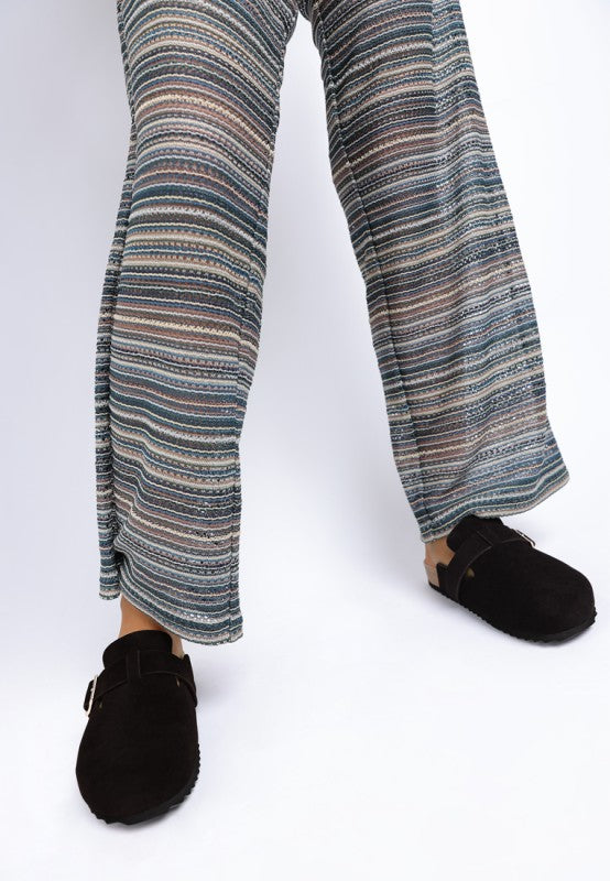 Model wearing Black Ratiha Mules front view with pointed round toe and buckle strap.