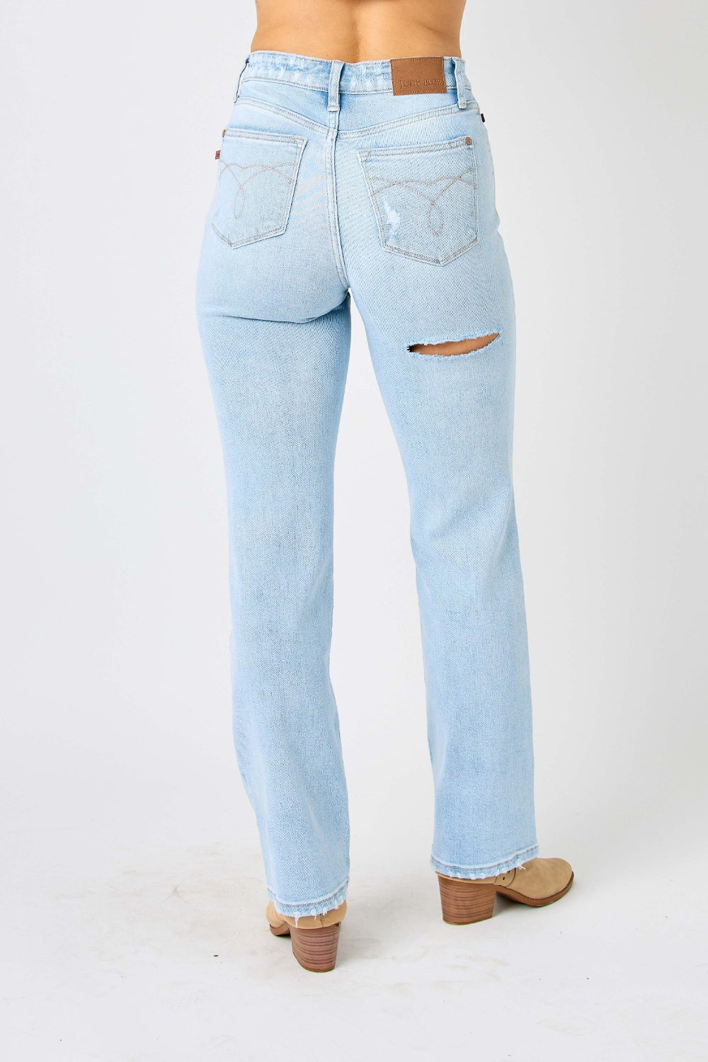 High waist distressed straight jeans in light wash. Slightly stretchy with a zip fly closure.