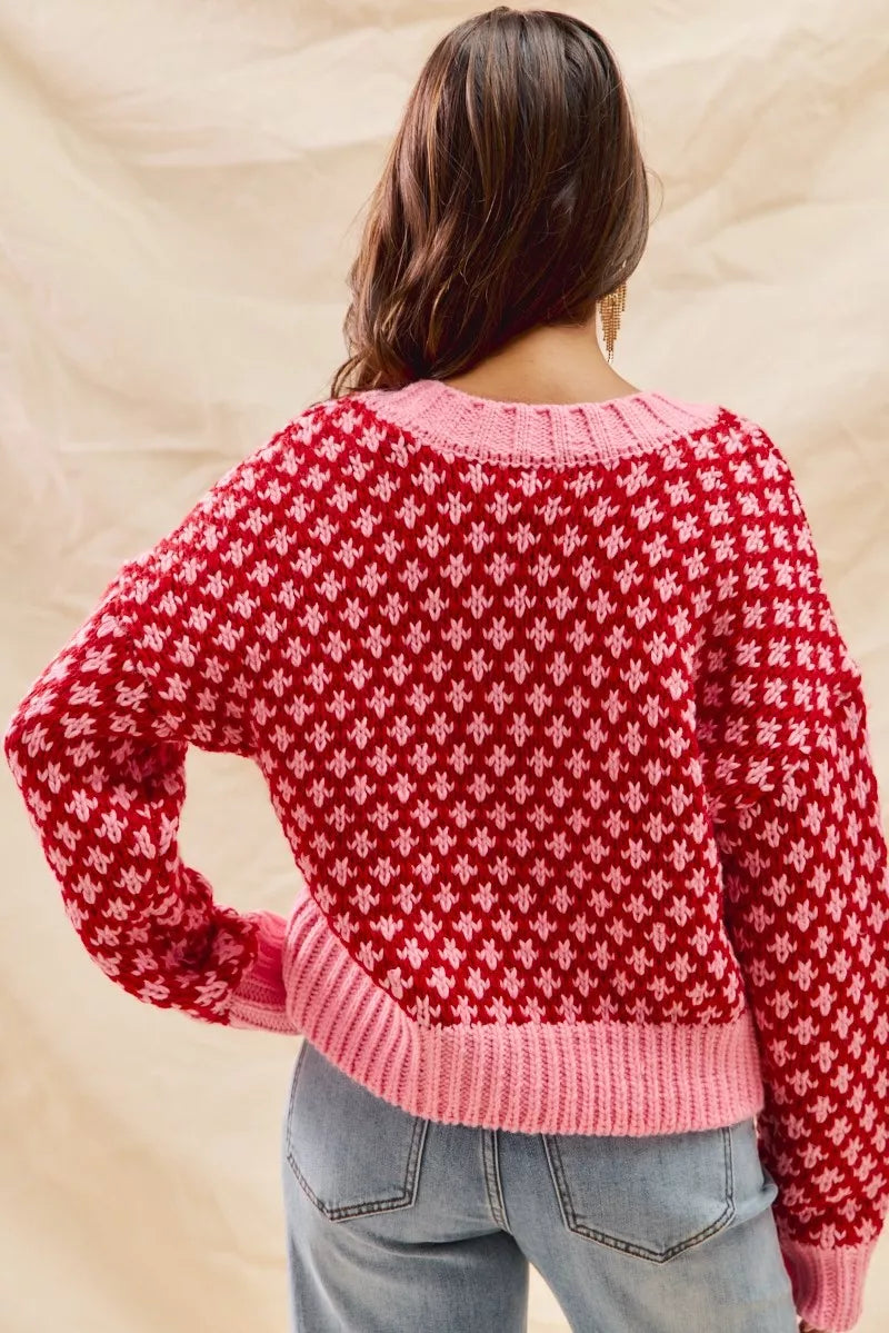 Back view of Chloe diamond knit sweater in red and pink color block design.