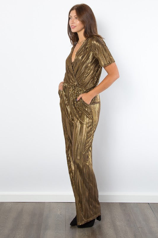 Gold Foil Accent Jumpsuit features a V-neck, short sleeves, pleats, foil details, wide-leg, and pockets.