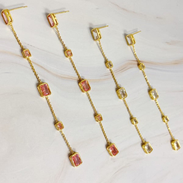 Flat lay of blush pink and clear variants of Five Stones Dangle Drop Earrings side by side