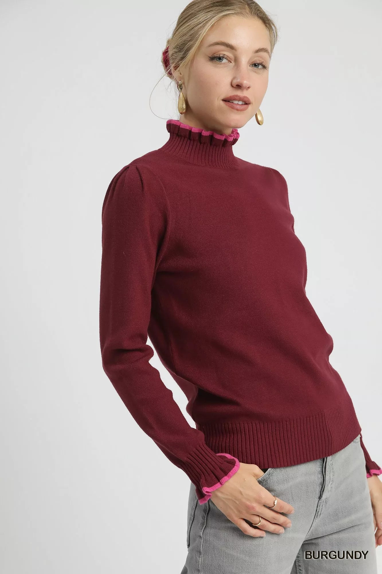 Side angle: Burgundy ruffle trim sweater with ribbed knit texture, cozy winter style.