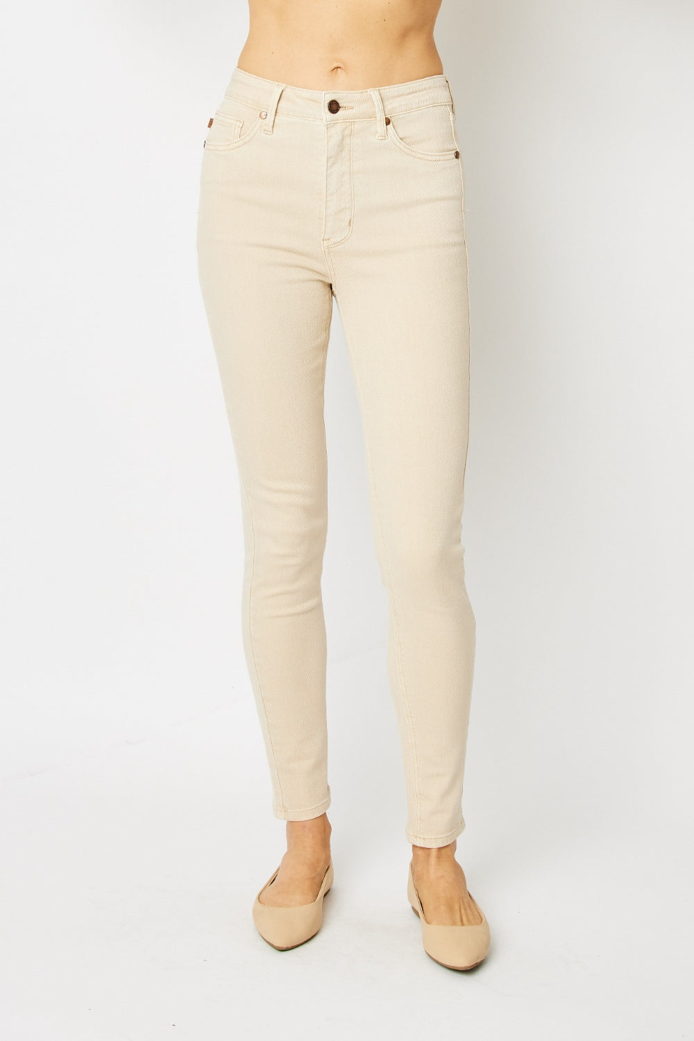 High-rise skinny jeans in bone with tummy control panel and zip fly. Slightly stretchy for comfort.