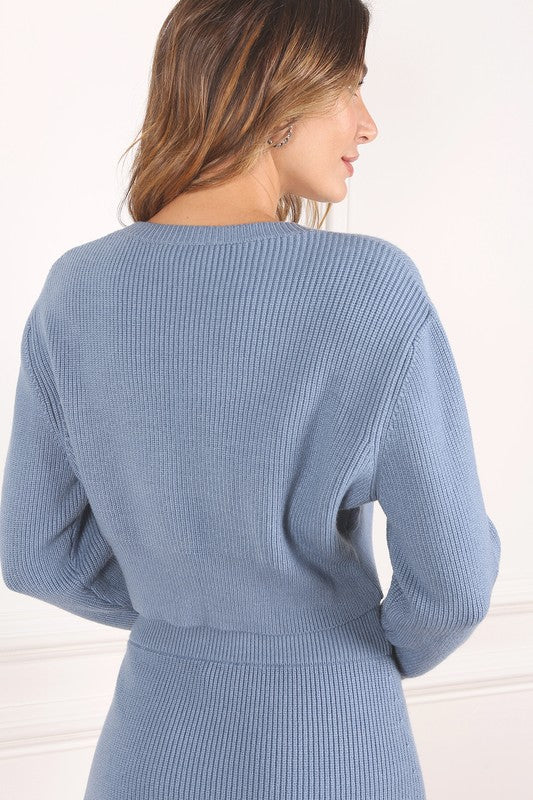 Ribbed knit crop top and mini skirt set in blue, featuring a round neckline, long sleeves, and a high waist skirt for a coordinated, stylish look.