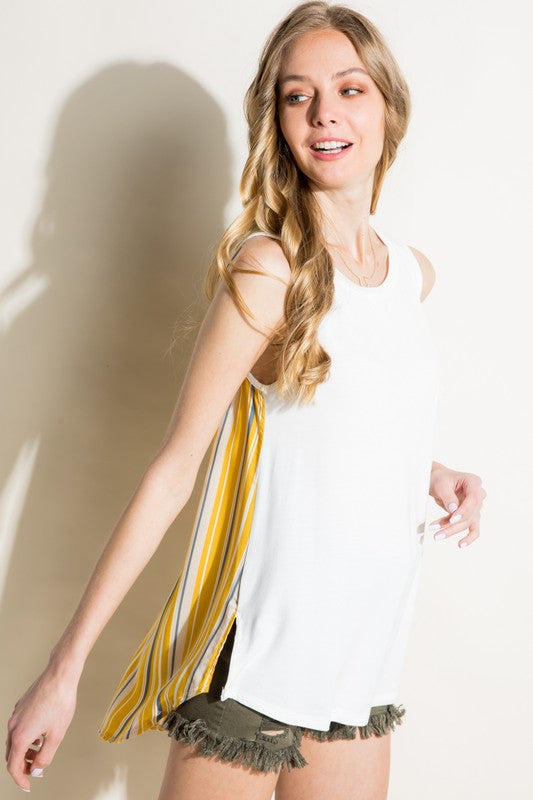 Mustard mixed-pattern tank top with a solid white jersey front, a vibrant striped back, a round neckline, and a sleeveless design, featuring a chest pocket.