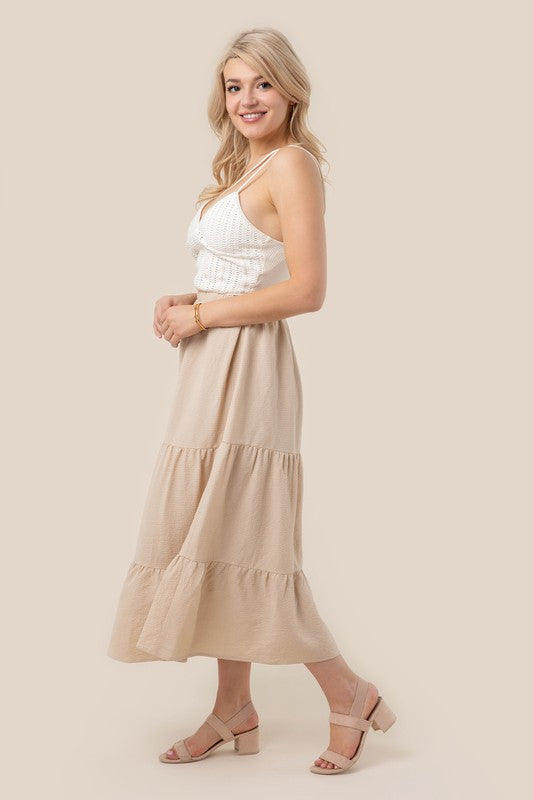 Tiered maxi skirt with elastic waistband in beige. Flowy silhouett, lined for full coverage.