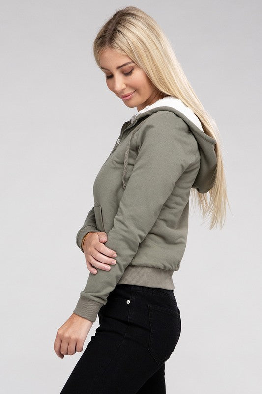 Military green cropped zip-up hoodie with fuzzy trim, pockets, and long sleeves.