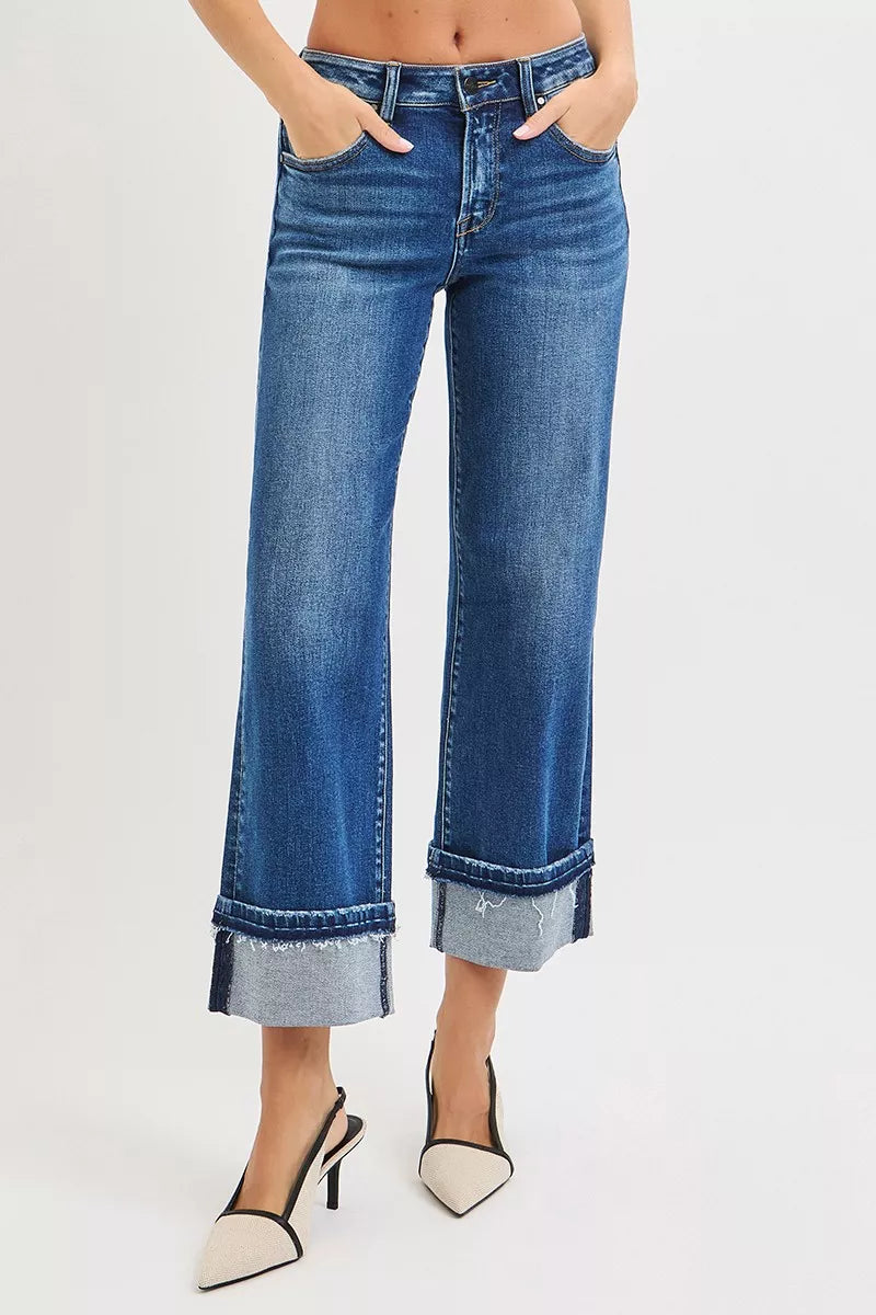 Model wearing Vera Mid Rise Straight Jeans in dark wash with cuffed hem.