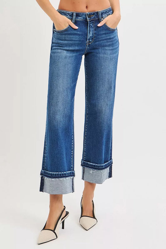 Model wearing Vera Mid Rise Straight Jeans in dark wash with cuffed hem.