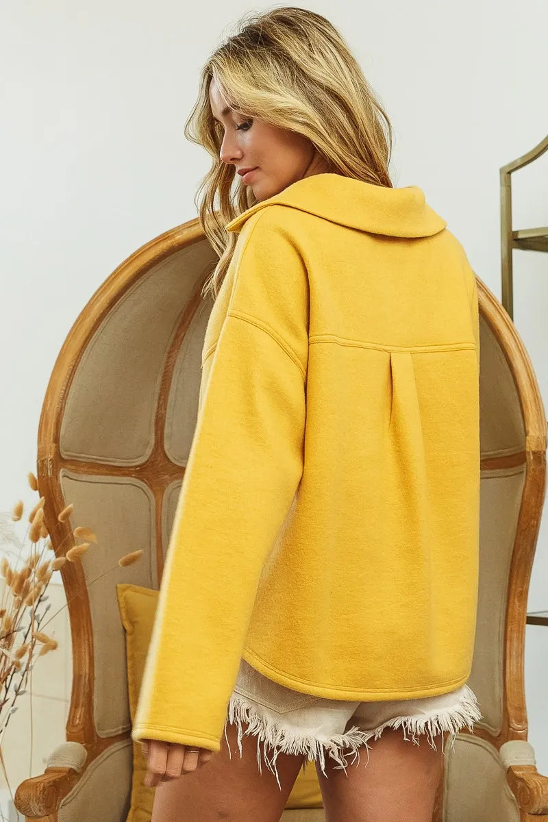 Back view of fleece collared sweatshirt in honey mustard with buttoned design and relaxed fit.