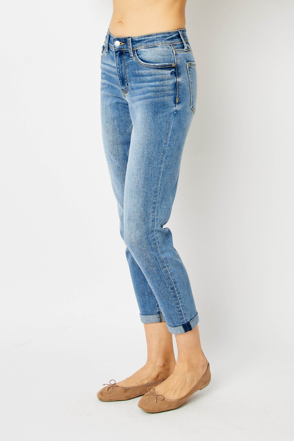 Mid-rise slim fit jeans with cuffed hems and a zip fly. Medium wash, highly stretchy fabric.