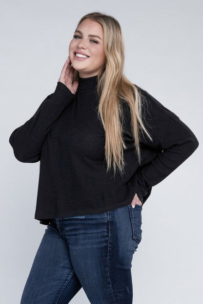 Plus size model wearing Raya Curvy Plus Drop Shoulder Top in black with mock neck.