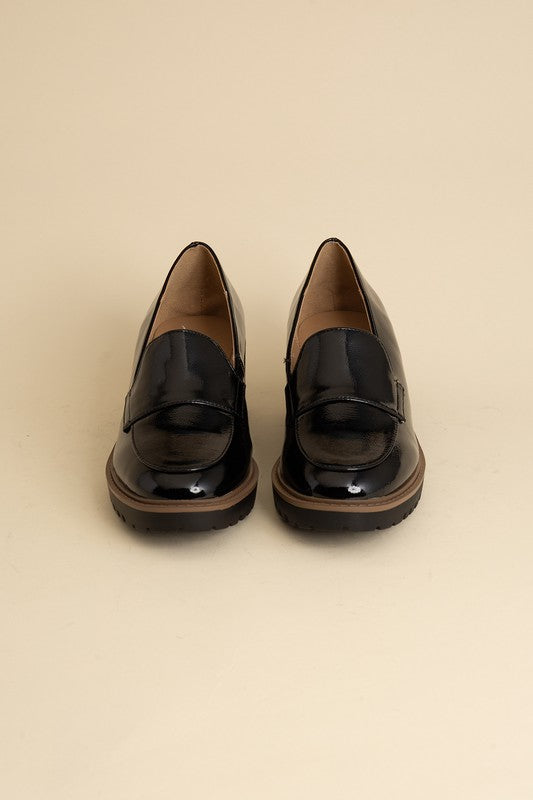 Chunky loafers in black feature a sleek design with a 2.3" heel.