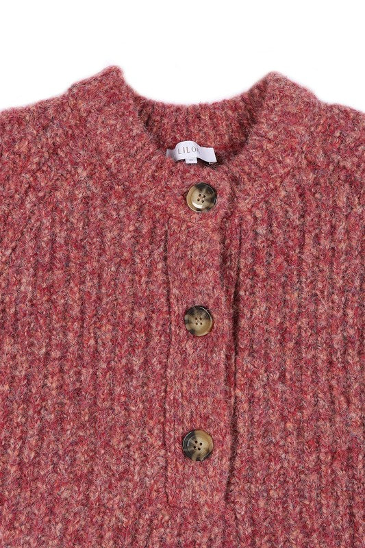 Women's half button down, cropped cardigan in purple and red melange pattern with functional buttons, round neckline, and long raglan sleeves.