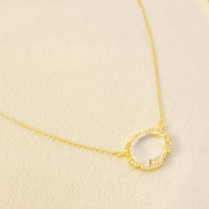 Clustered Glass Jewel Necklace with clear glass stone and gold chain, minimal flat lay.