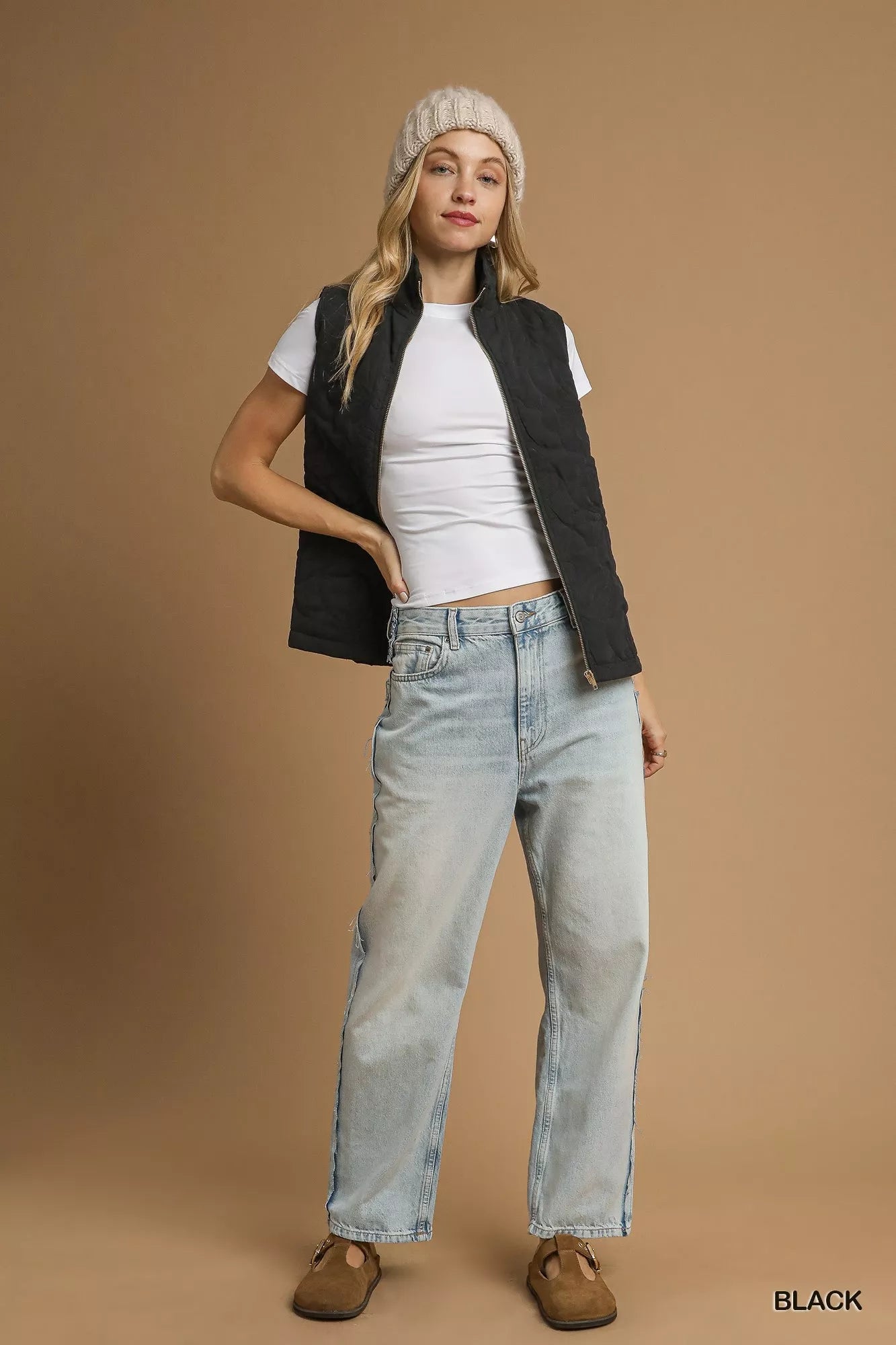 Model wearing Noor Quilted Floral Black Vest with jeans and beanie, full body view