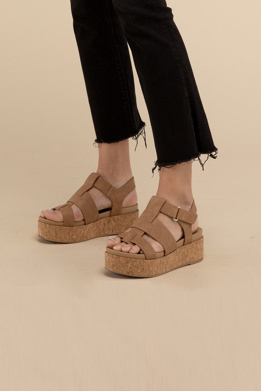 Coffee-colored platform wedge sandals with a buckle closure and 1.5" heel.