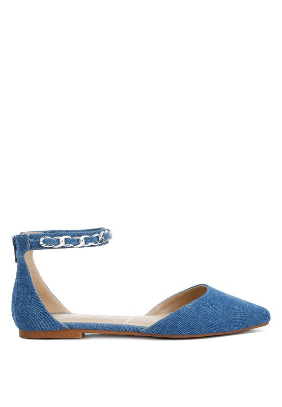 Denim flats with a pointed toe, chain ankle strap, and flat heel .