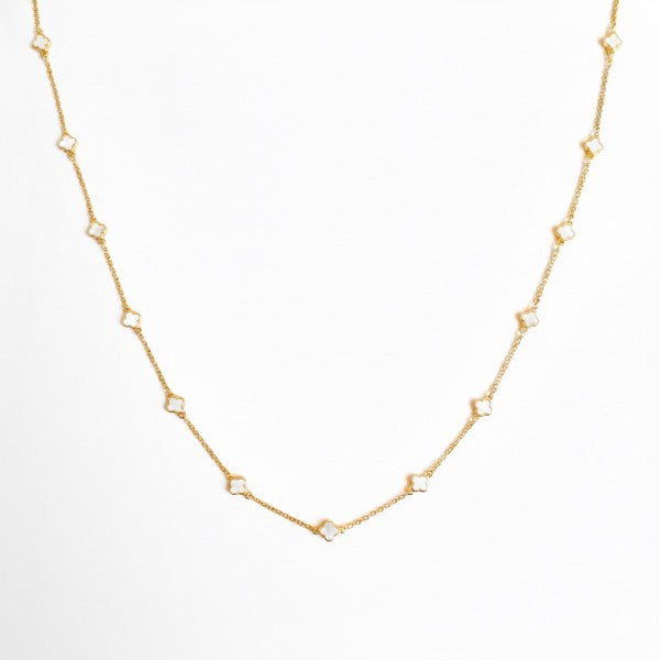 Flat lay of Petite Colored Clover Necklace with cream clover pendant.