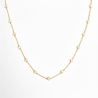 Flat lay of Petite Colored Clover Necklace with cream clover pendant.