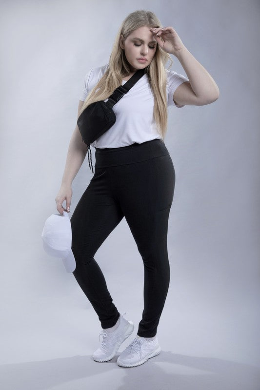 Full-length curvy plus leggings in black with a high-rise thick waistband, fitted silhouette, and convenient leg pockets.