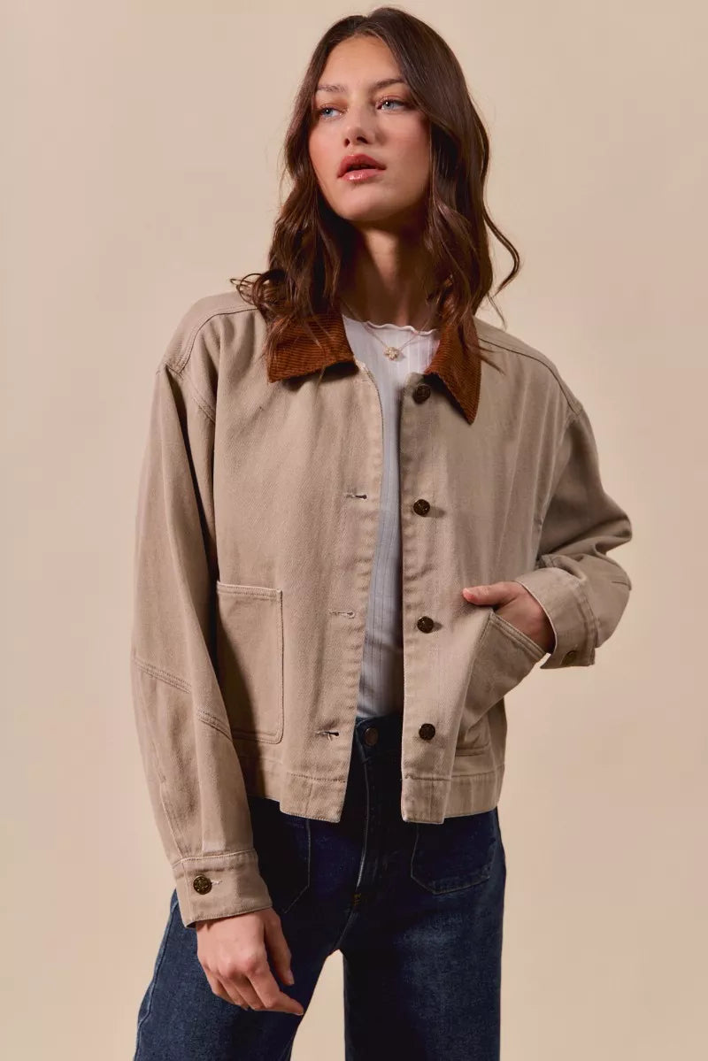 Suri Cotton Twill Cropped Barn Jacket in Taupe displayed open over a white top for layering.
