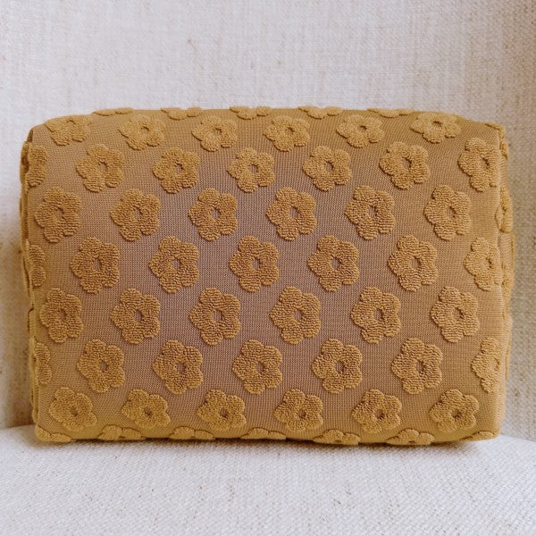 Taupe Embossed Daisy Blossom Cosmetic Case with golden daisy zipper pull and embossed floral pattern.