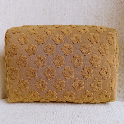 Taupe Embossed Daisy Blossom Cosmetic Case with golden daisy zipper pull and embossed floral pattern.