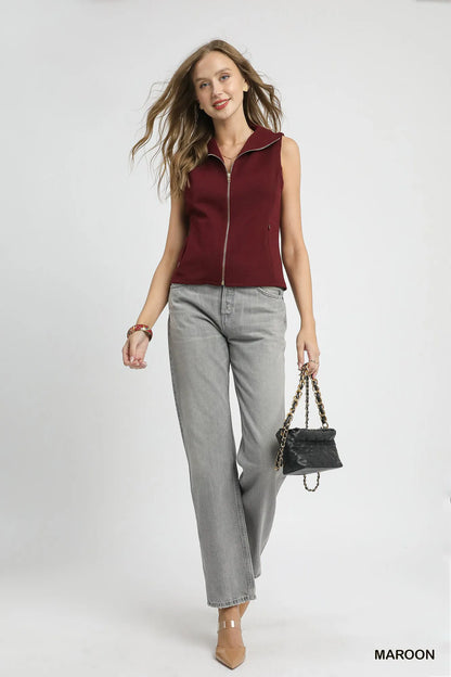 Full body view of Zahra Zip-Front Fitted Vest styled with jeans, showing zip-front and pocket details.