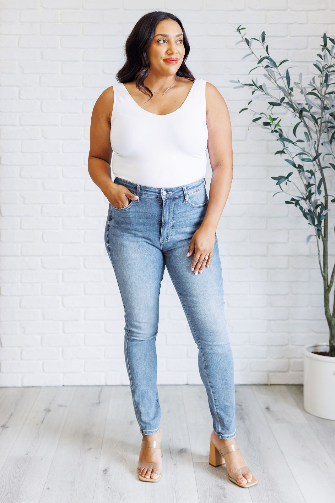 Plus Size Justine High Rise Skinny Jeans by Judy Blue in a light contrast wash, featuring a zip fly, tummy control panel, and high-rise waist for a flattering fit.