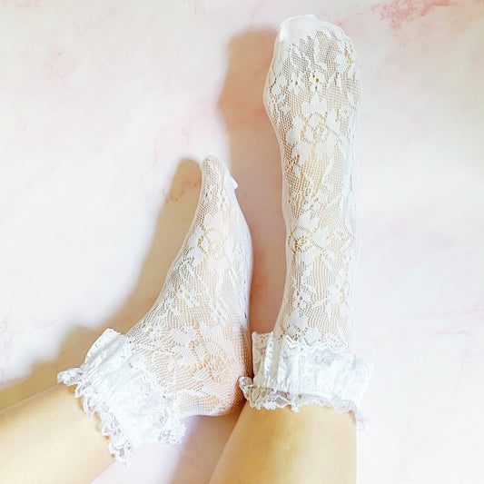 Woman wearing white 80’s Lace Socks with delicate lace pattern and double lace ankle trim.