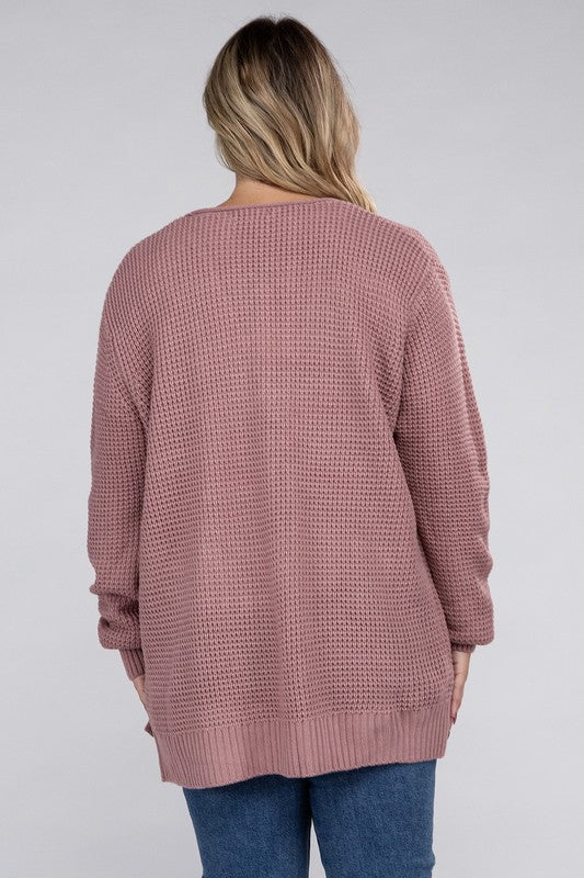 Curvy plus-size waffle-pattern open cardigan sweater in light rose, with long sleeves, oversized fit, and pockets.