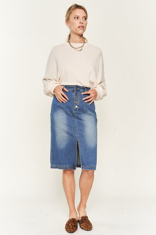 Denim button-down midi skirt with a front slit, belt loops, and back pockets. Features a high waist with an elasticized waistband in the back.