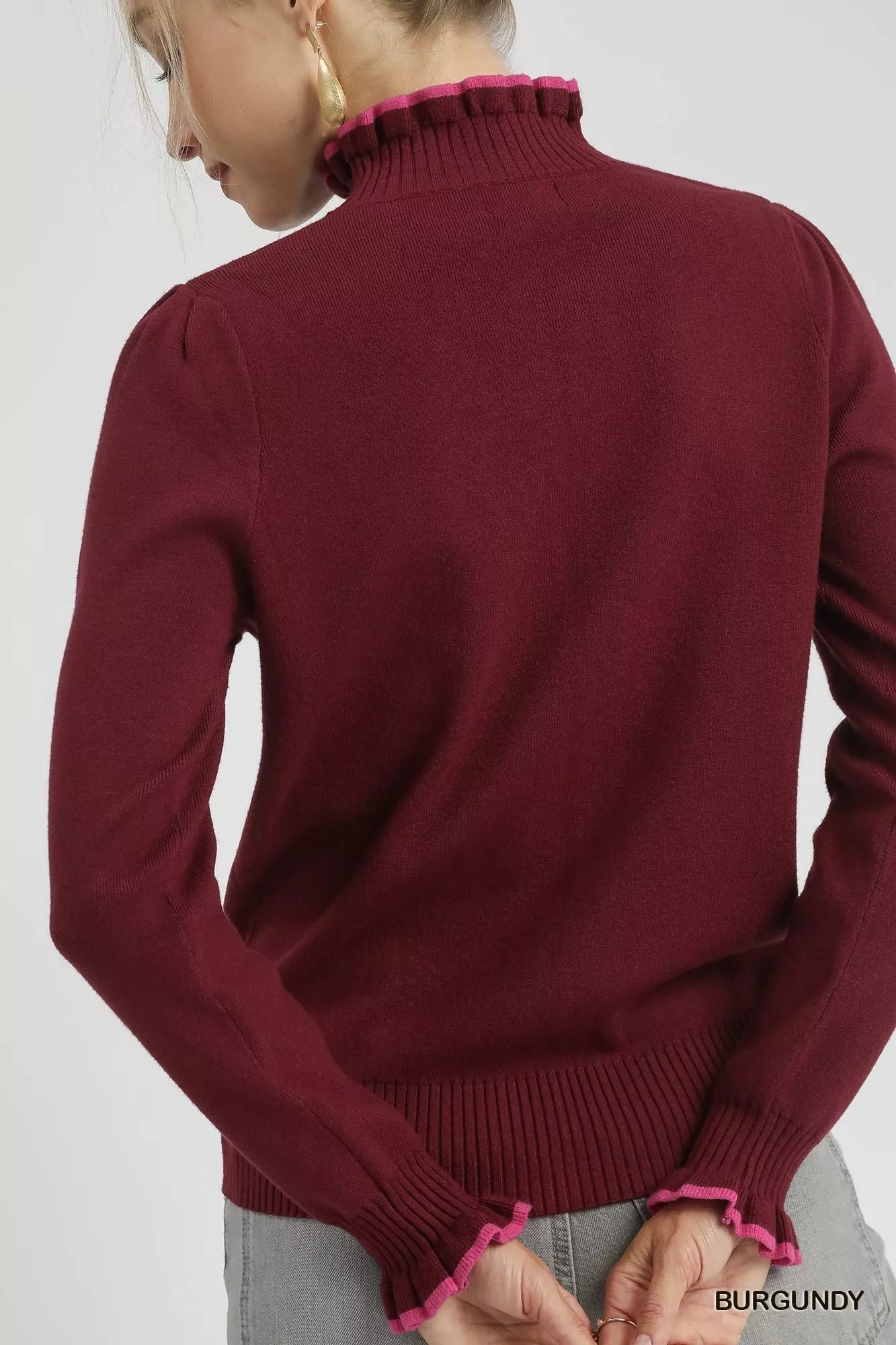 On model back: Burgundy ribbed knit sweater, back displayed on hanger, winter style.