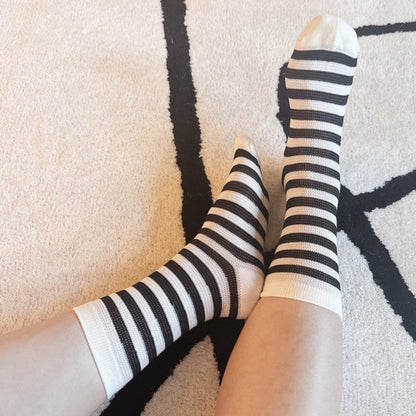 Woman wearing black and white striped Urban Stripes Socks for everyday style.