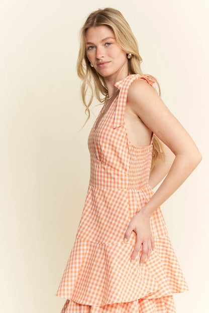 Side view of Alice Gingham Tiered Midi Dress showing halter tie straps and ruched back detail, with flowing tiered skirt and gingham pattern.