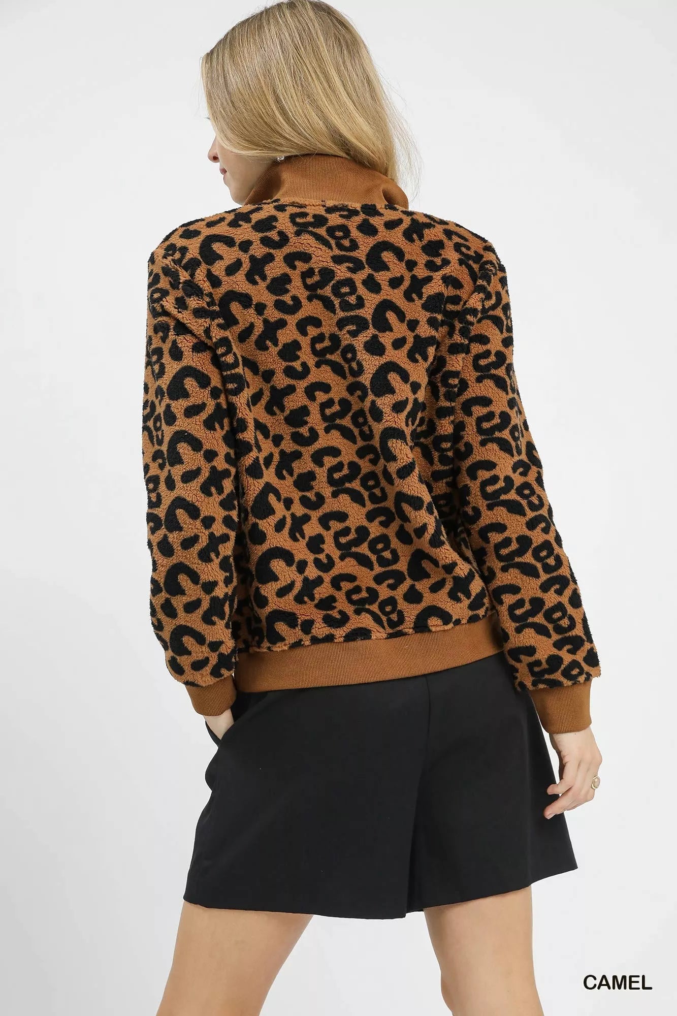 Back angle camel brown leopard fleece quarter-zip sweatshirt, ribbed hem and cuffs.