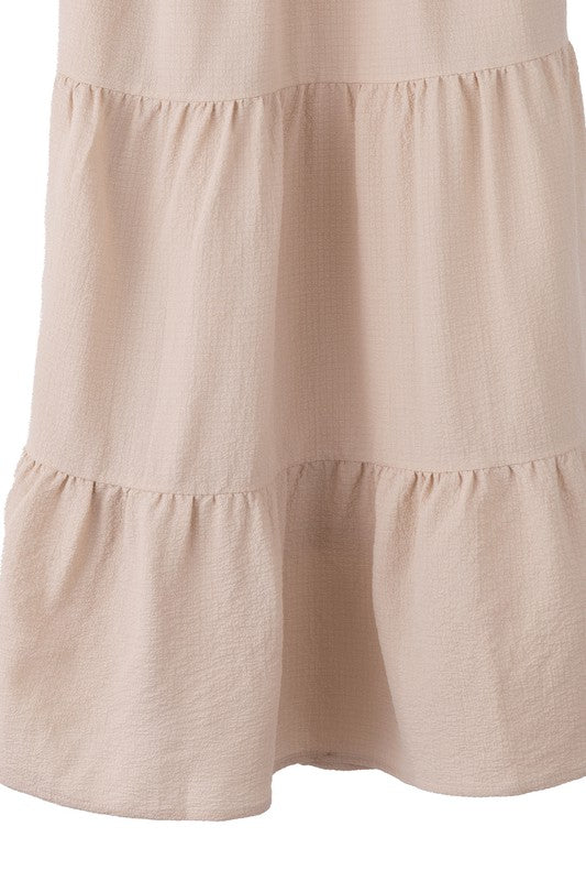 Tiered maxi skirt with elastic waistband in beige. Flowy silhouett, lined for full coverage.