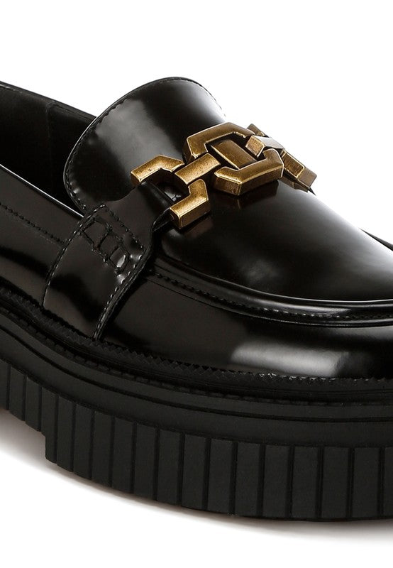 Close-up of black Grosbeak Chunky Loafers gold hardware detail.