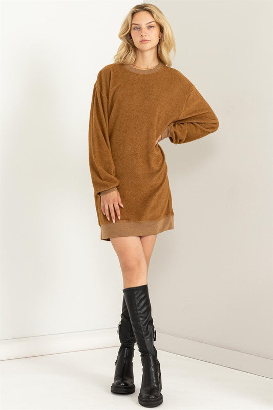 Pale brown girlfriend sweatshirt mini dress with a crew neckline and cuffed hem, drop shoulders, long sleeves, and a relaxed fit. 