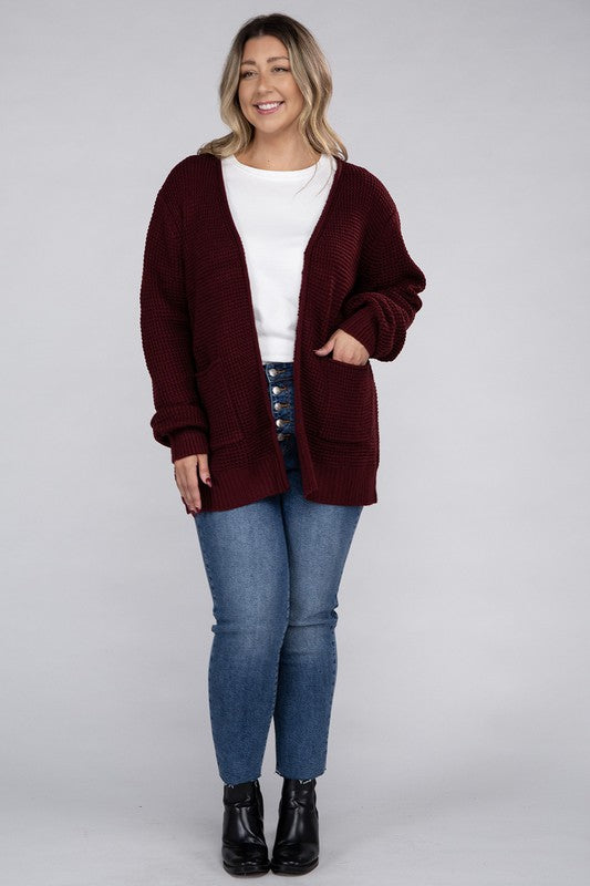 Curvy plus-size waffle-pattern open cardigan sweater in dark burgandy, with long sleeves, oversized fit, and pockets.