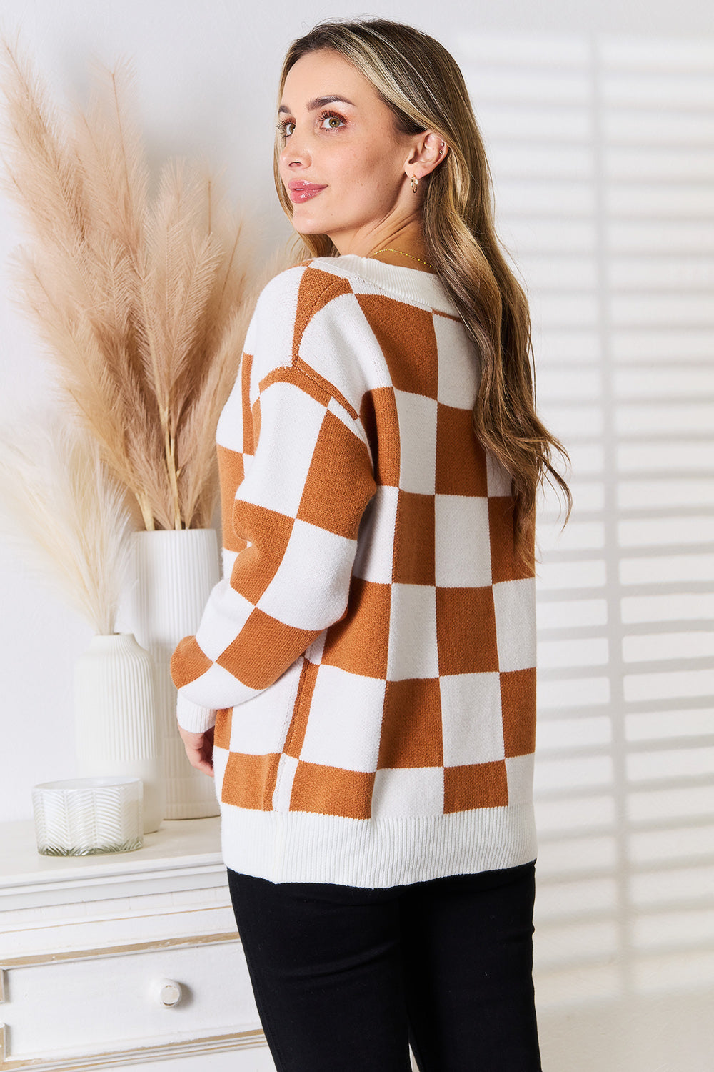 Back of Tauni Checkered Cardigan, showcasing bold checkered pattern and relaxed silhouette