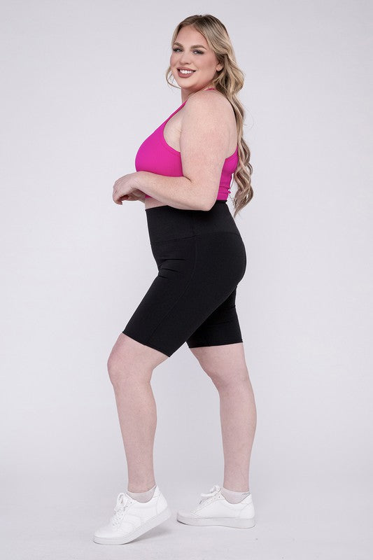 High-rise plus-size athletic biker shorts in black, featuring a fitted silhouette and seamless design for comfort and flexibility.